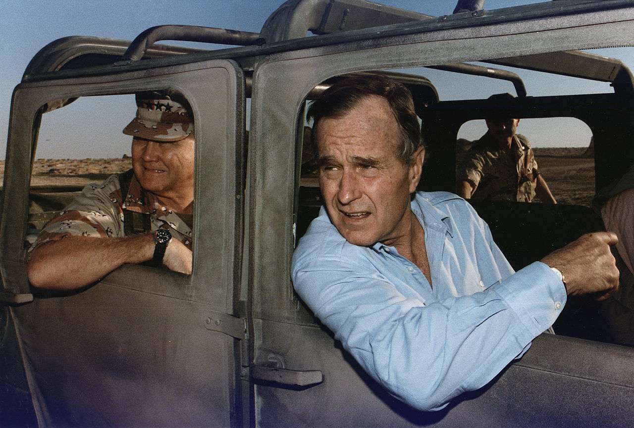 U.S. President George H. W. Bush riding in a Humvee with General Schwarzkopf in Saudi Arabia