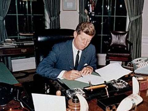 President Kennedy signs the Proclamation for Interdiction of the Delivery of Offensive Weapons to Cuba at the Oval Office on October 23, 1962