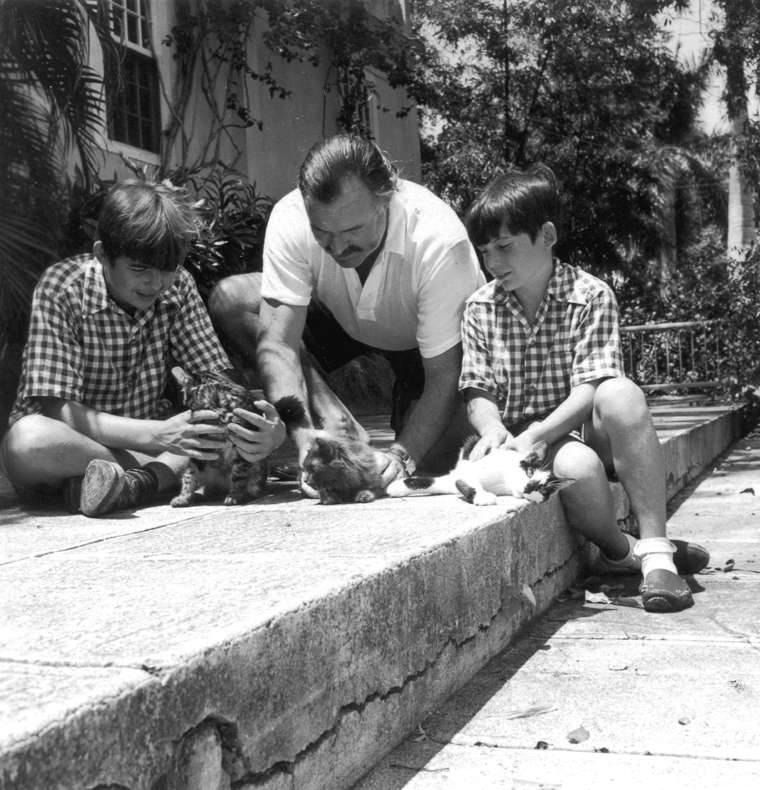 Hemingway and sons Patrick (left) and Gregory, with three cats at Finca Vigía c. mid-1942