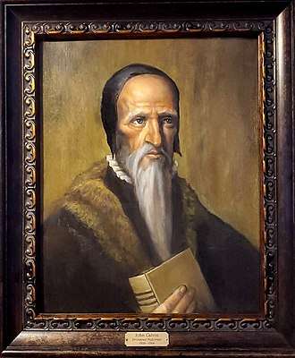 Modern depiction of John Calvin in his later years, holding the Scriptures (Geneva Bible)