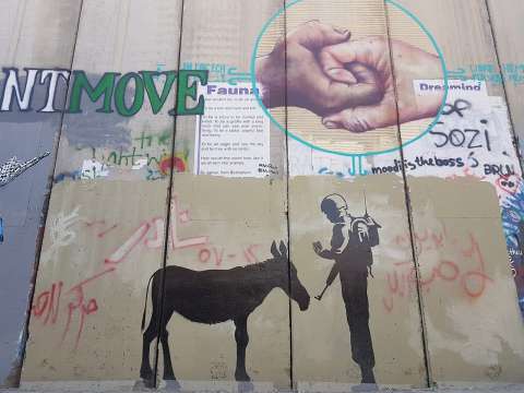 Graffiti by Banksy on the West Bank barrier
