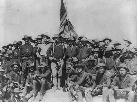 Colonel Roosevelt and the Rough Riders after capturing Kettle Hill in Cuba in July 1898, along with members of the 3rd Volunteers and the regular Army black 10th Cavalry