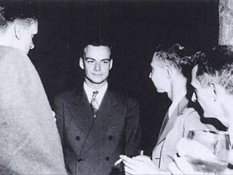 Feynman (center) with Robert Oppenheimer (immediately right of Feynman) at a Los Alamos Laboratory social function during the Manhattan Project