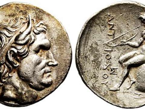 Tetradrachm of Antiochus I. Obv: Seleucus I, with bull's horns. Rev: Apollo, with a bow, seated on the omphalus