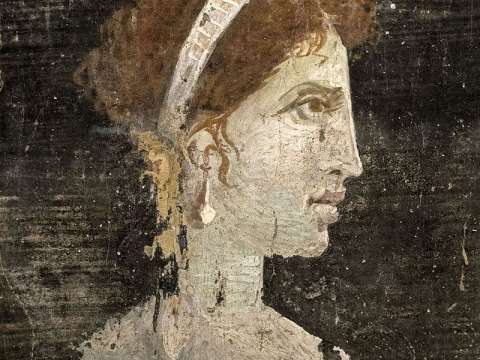 Most likely a posthumously painted portrait of Cleopatra with red hair and her distinct facial features, wearing a royal diadem