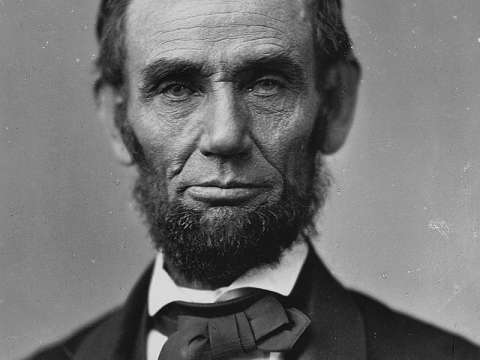  An iconic photograph of a bearded Abraham Lincoln showing his head and shoulders.