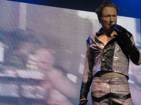 O'Brien performing in a replica of the costume Eddie Murphy wore in Eddie Murphy Raw (2010).