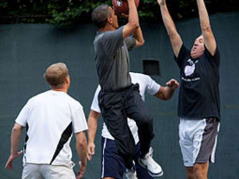 Obama takes a left-handed jump shot during a pickup game on the White House basketball court, 2009
