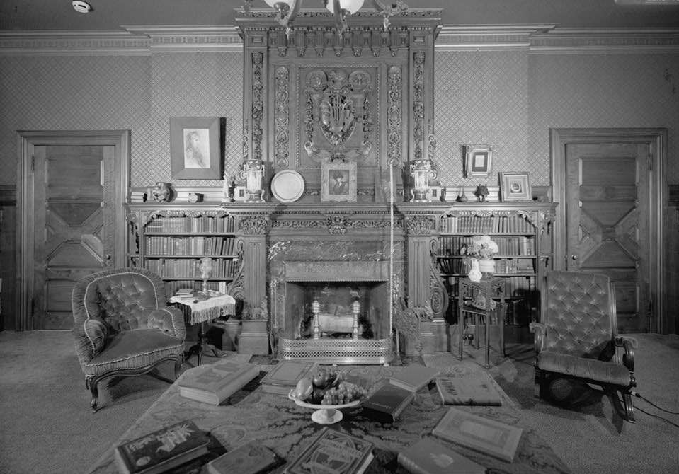 Library of Twain House, with hand-stenciled paneling, fireplaces from India, embossed wallpaper, and hand-carved mantel from Scotland