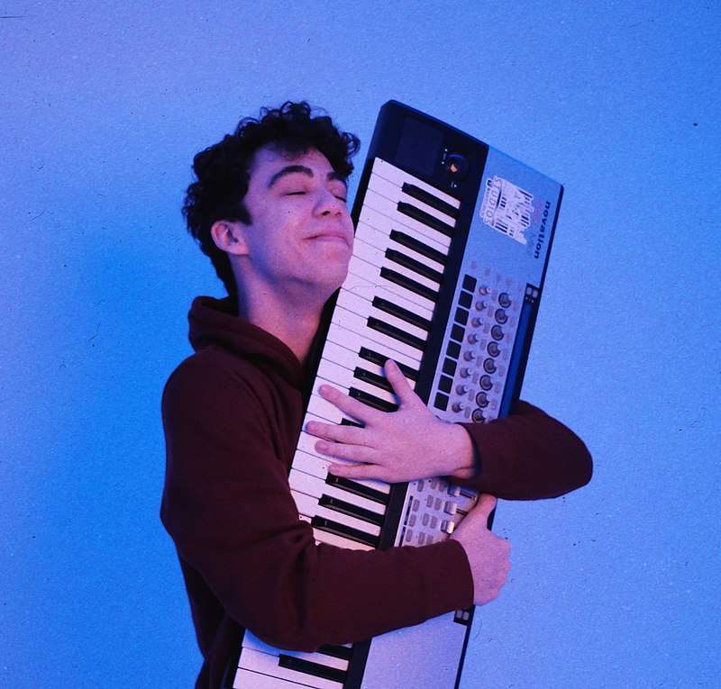 Bortnick holding a synthesizer