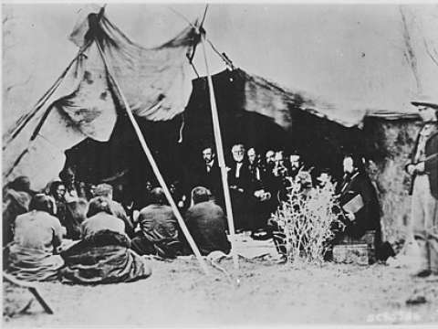 General Sherman (third from left) and other Indian Peace Commissioners in council with native chiefs and headmen, at the signing of the Treaty of Fort Laramie in 1868