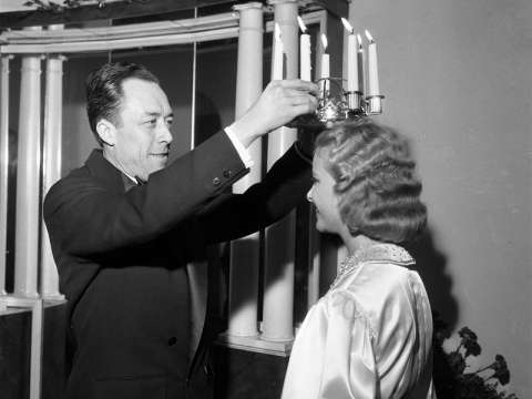 Camus crowning Stockholm's Lucia on 13 December 1957, three days after accepting the Nobel Prize in Literature.