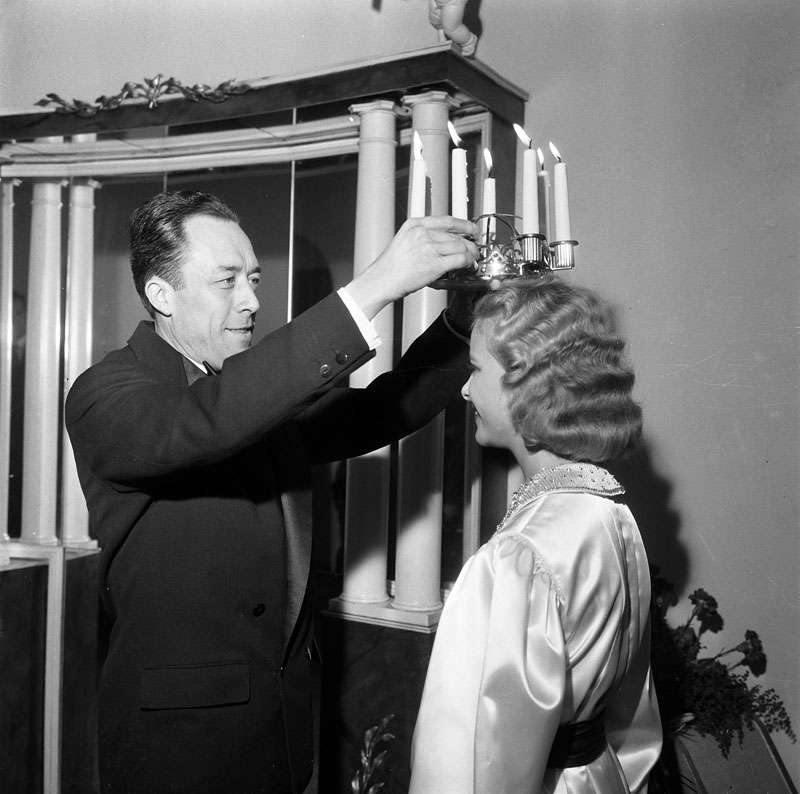 Camus crowning Stockholm's Lucia on 13 December 1957, three days after accepting the Nobel Prize in Literature.