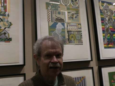 Michael Grost in front of some paintings