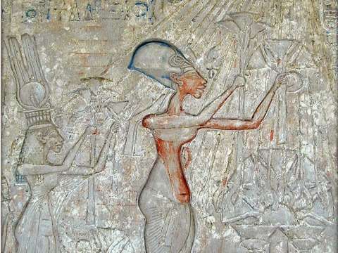 Pharaoh Akhenaten (center) and his family worshiping the Aten, with characteristic rays seen emanating from the solar disk. Later such imagery was prohibited.