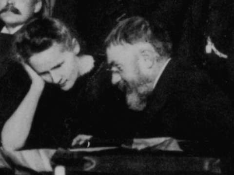 Marie Curie and Poincaré talk at the 1911 Solvay Conference