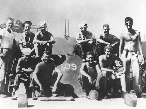 Lieutenant (junior grade) Kennedy (standing at right) with his PT-109 crew, 1943