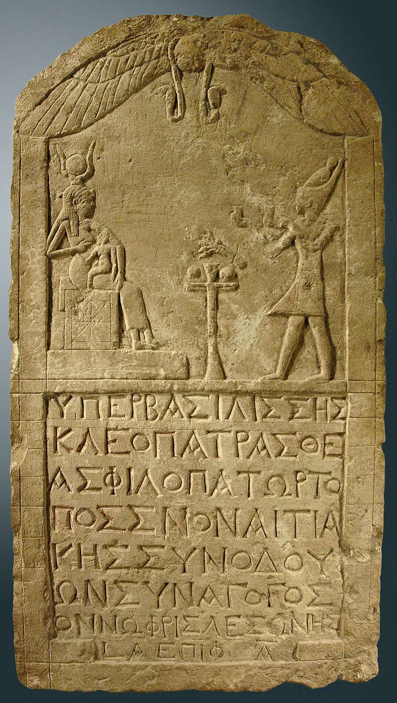 Cleopatra dressed as a pharaoh and presenting offerings to the goddess Isis, on a limestone stele dedicated by a Greek man named Onnophris