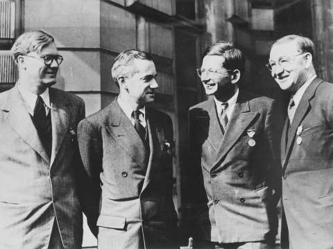 Key British physicists. Left to right: William Penney, Otto Frisch, Rudolf Peierls and John Cockcroft. They are wearing the Medal of Freedom.