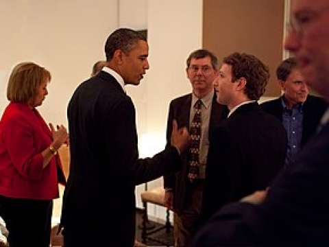 Zuckerberg listening to President Barack Obama before a private meeting where Obama dined with technology business leaders in Woodside, California, February 17, 2011.