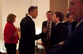 Zuckerberg listening to President Barack Obama before a private meeting where Obama dined with technology business leaders in Woodside, California, February 17, 2011.