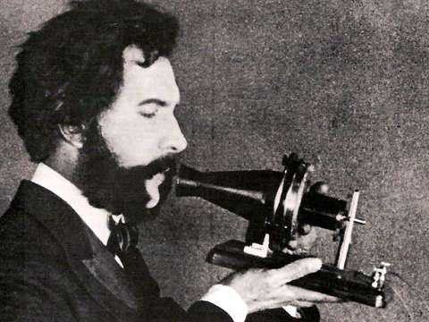 An actor playing Bell in a 1926 film holds Bell's first telephone transmitter