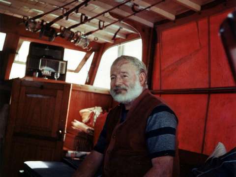 Hemingway in the cabin of his boat Pilar, off the coast of Cuba, c. 1950