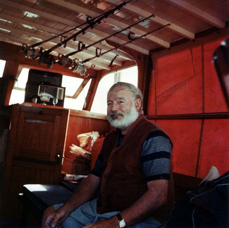 Hemingway in the cabin of his boat Pilar, off the coast of Cuba, c. 1950