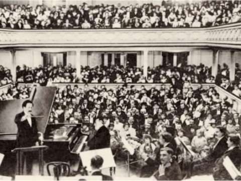 Saint-Saëns at the piano for his planned farewell concert in 1913, conducted by Pierre Monteux