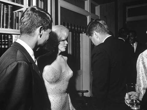 Attorney General Robert F. Kennedy, Marilyn Monroe, and John Kennedy talk during the president's May 19, 1962, early birthday party